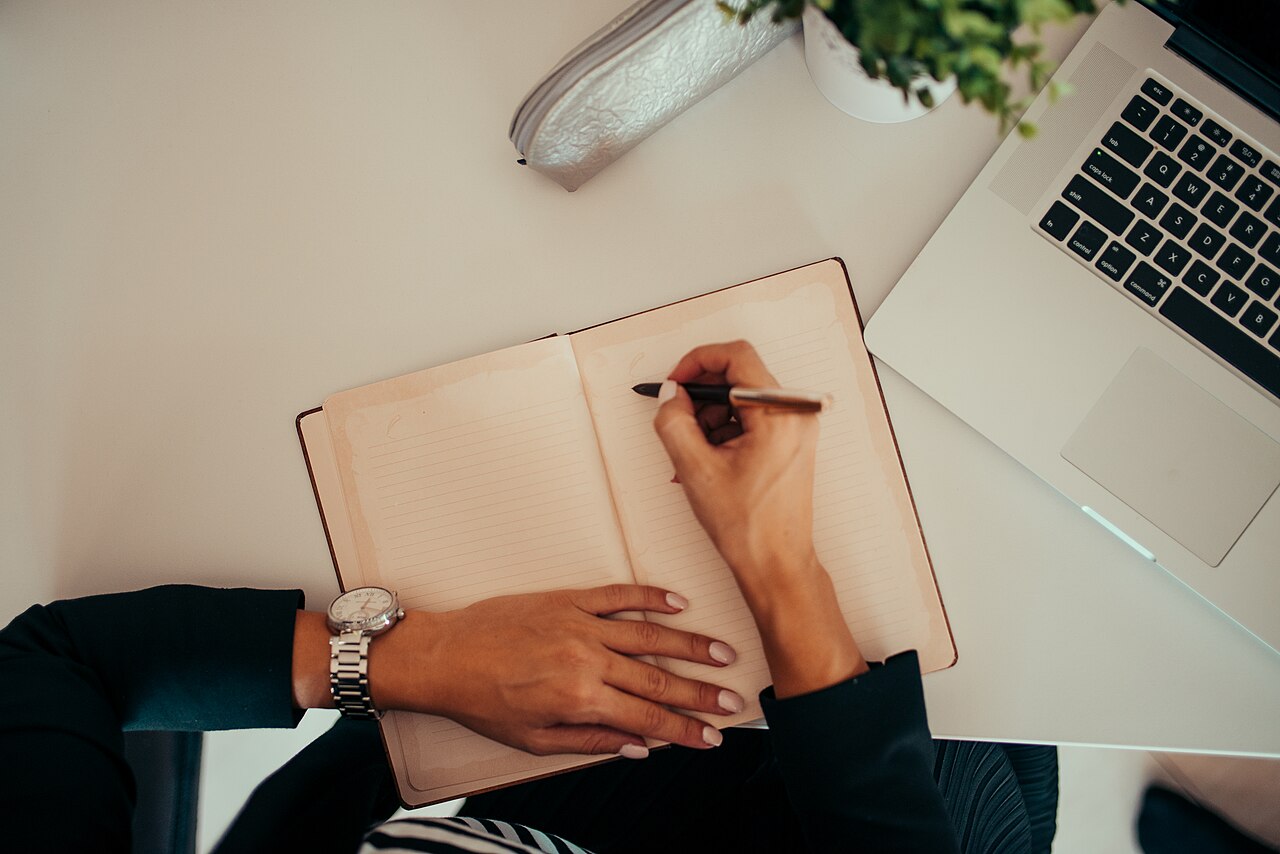 Planning notes next to a laptop